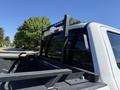 A 2017 Ford F-350 Super Duty pickup truck with a black bed rack installed in the truck bed