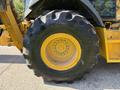 2013 John Deere 710K backhoe loader tire with deep treads and yellow rim