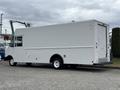 A white 2018 Ford Econoline box truck with a flat rear and no visible signage parked to the side
