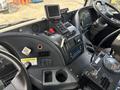 Interior dashboard of a 2012 Autocar Xpert featuring controls, gauges, a digital display, and a key in the ignition along with various buttons and levers