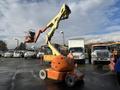 A 2012 JLG E400AJFN articulated boom lift with an orange base and yellow arm extending upward with a red basket at the top