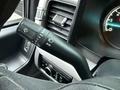 Close-up of a 2023 Ford F-250 interior showing the control stalk on the steering column featuring turn signal and windshield wiper controls