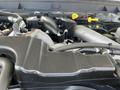 Engine compartment of a 2014 Ford F-250 SD showing various components like pipes and an intake manifold