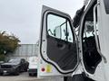 A white 2013 Freightliner 114SD truck door is open revealing the interior with a driver's seat and controls visible inside