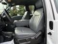 Interior view of a 2015 Ford F-350 SD featuring leather seats and a center console with armrest