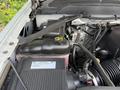 The engine compartment of a 2016 Chevrolet Silverado 2500HD showing various components including the radiator reservoir and air intake system