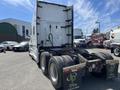 2022 Freightliner Cascadia truck with a white cab and four rear wheels visible at the back, showcasing the truck's chassis and rear features
