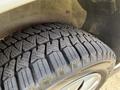 A close-up view of a treaded tire from a 2021 Ford Transit Connect showcasing deep grooves and a rugged design for improved traction