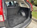 Interior of a 2014 Honda CR-V showing a spacious cargo area with black carpet and no visible cargo or items inside