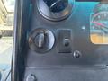 Dashboard controls of a 2012 Ford Econoline including dial for lights and switch for fog lights