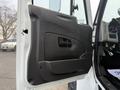 The door panel of a 2016 International 7400 featuring a black textured surface and a small handle