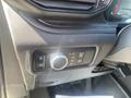 Close-up of the control panel in a 2020 Ford Explorer showing buttons for lights and vehicle settings with a circular dial