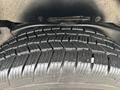 Close-up of a tire with a detailed tread pattern designed for traction on various surfaces