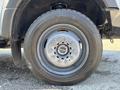 Close-up of a wheel and tire from a 2017 Ford F-550 showcasing a multi-spoke wheel design and heavy-duty tire tread