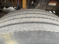 Close-up of a worn tire from a 2007 Freightliner B2 showing visible tread wear and cracks on the rubber surface