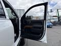 A 2017 Chevrolet Silverado 1500 with the driver's side door open showcasing the interior features and wood accents on the door panel