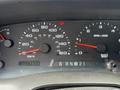 Dashboard of a 2004 Ford F-350 SD showing speedometer odometer and RPM gauge with various indicator lights