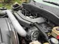 Close-up of the engine compartment of a 2014 International TerraStar showing various components such as pipes, hoses, and the engine block