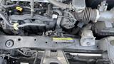 Close-up view of the engine compartment of a 2019 Nissan Kicks showing various components including hoses and wires