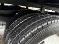 Close-up of the tires on a 2024 Ford E-450 showing detailed tread patterns and rubber texture