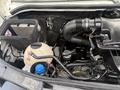 A 2016 Mercedes-Benz Sprinter engine compartment showing various components including an air filter a fluid reservoir and hoses