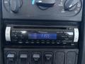 A Pioneer car stereo displaying the time 1155 with various buttons for volume tuning and playback controls