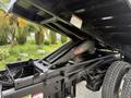 A 2017 Ford F-750 truck showing the dump bed mechanism and hydraulic system in detail