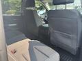 Interior view of the rear seating area of a 2017 Chevrolet Silverado 1500 with black fabric seats and a clean design