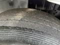 Close-up of a treaded tire from a 2012 International DuraStar 4300 with visible wear patterns and a textured surface