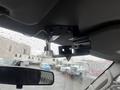 Interior view of a 2009 Ford Econoline showing the overhead console with a mount and wiring visible under a rearview mirror