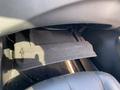 A black glove compartment of a 2017 Nissan Murano with a slightly dusty interior and a partially open lid