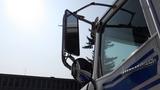 A 2003 International 5600i truck with a chrome side mirror and arm visible in the foreground