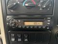 The image shows the dashboard control panel of a 2013 International DuraStar 4300 featuring radio controls and various switches for vehicle functions