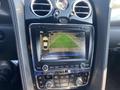 A 2015 Bentley Continental GT dashboard with a navigation screen displaying a rearview camera image of a parking area and surrounding guidelines