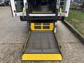 A 2021 Ford Transit-350 with a lowered ramp for accessibility positioned at the rear of the vehicle