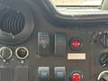Close-up of the dashboard controls of a 2012 Ford E-450 Super Duty including switches and gauges