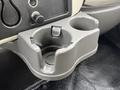 A gray cup holder with grips designed to hold beverages securely in a 2013 International Workstar 7500 truck interior