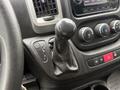 Close-up of a 2020 RAM Promaster gear shift lever with a leather cover and nearby climate control dials and buttons