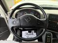 The interior of a 2016 International 7400 showing the steering wheel with controls and dashboard instruments alongside a thank you note on the floor