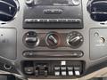 Dashboard controls of a 2008 Ford F-250 SD featuring knobs for air conditioning and audio settings