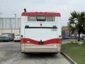A 2016 Grande West Vicinity bus with a red and white color scheme facing backward with the number 2038 displayed on the back