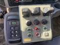 Control panel featuring various switches and knobs labeled for functions like hoist, flow, and granular control on a 2014 International 7400
