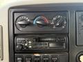 The image shows the dashboard controls of a 2008 International 4300 including temperature dials and a Panasonic radio with various buttons and knobs