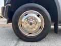 A close-up of a shiny chrome wheel with multiple bolts on a 2009 Ford F-450 Super Duty tire