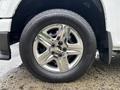 Close-up of a chrome wheel rim on a 2011 Chevrolet Colorado with a black tire showing the brand name and tread pattern