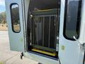 A 2013 Ford Econoline with a wheelchair lift folded inside the rear entryway