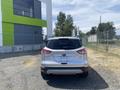 A 2015 Ford Escape parked with its rear facing the viewer showcasing its sleek design and silver color