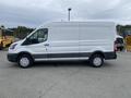 White 2024 Ford Transit van with a high roof and sliding side door parked on a flat surface
