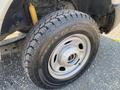 Close-up of a tire on a 2017 Ford F-250 SD featuring a rugged tread pattern and a silver wheel rim with a central opening