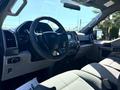 Interior view of a 2018 Ford F-150 showing the dashboard steering wheel and front seats